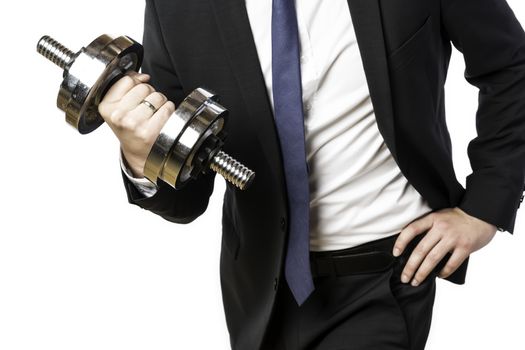 Businessman in black suit holding a silver dumbbell in the right hand