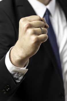 Businessman in black suit holding up his clenched fist