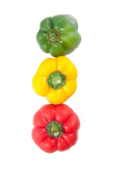 Three sweet peppers in yellow, red and green color on white background