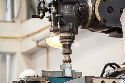 Shot of an old milling machine in a workshop.