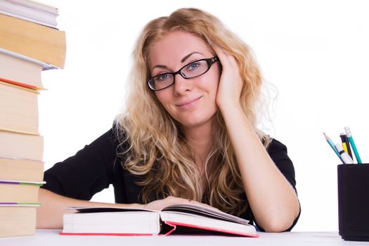 Smiling student girl with pile of books isolated on white