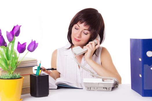 Pretty businesswoman talking on phone at office over white