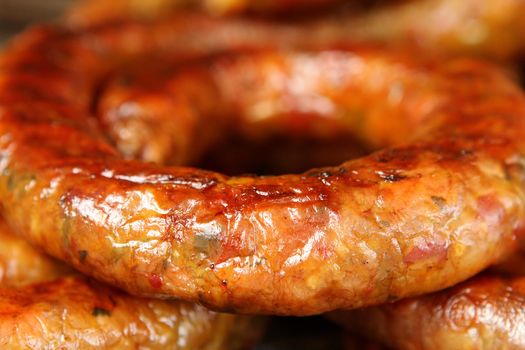 Appetizing fried homemade sausage ring - close-up