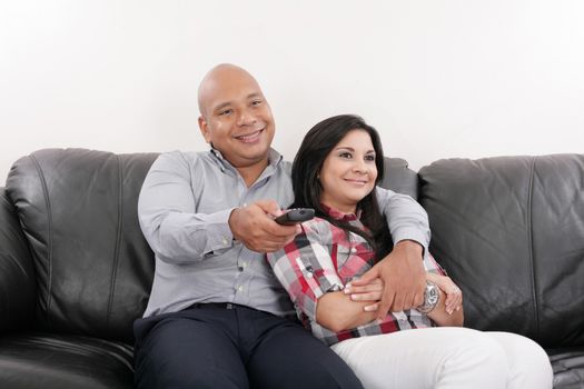 Young couple watching tv on a sofa