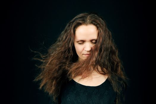 attractive girl with closed eyes and flowing long hair