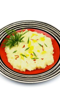 Mashed Potato Garnished with Dill, Spring Onion, Leek and Chili on Red Plate isolated on white background