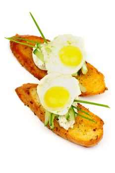 Delicious Snacks with Cream Cheese, Cucumber, Spring Onion and Quail Egg on Toasted Bread isolated on white background