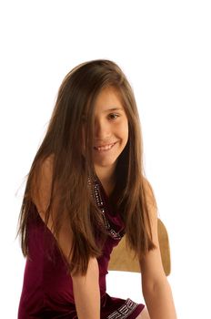 Attractive Teen Girl with Long Brown Hair in Purple Dress Sitting on Chair and Smiling