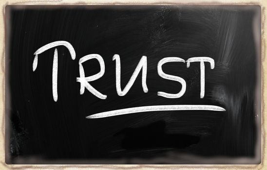 trust written with chalk on blackboard.
