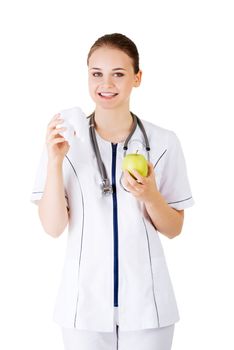 Female dentist with green apple and big tooth. Isolated on white