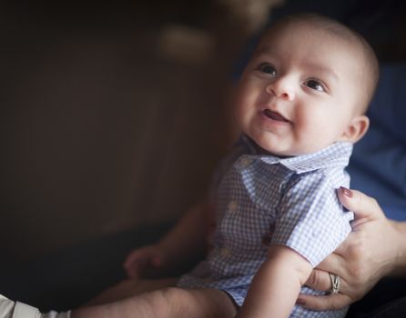 Cute Mixed Race Infant Having Fun with His Parents.