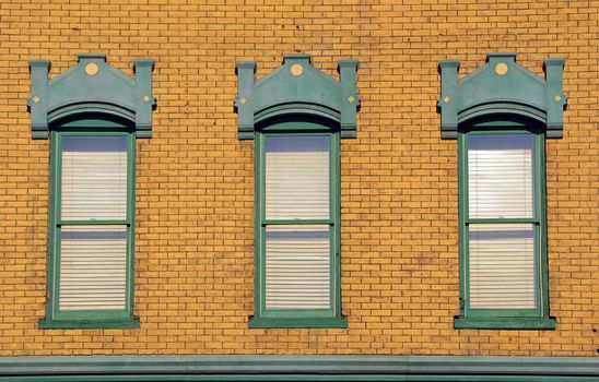 Old wooden windows in brick building wall