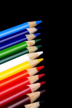 Color pencils isolated on black background