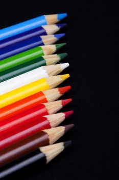 Color pencils isolated on black background