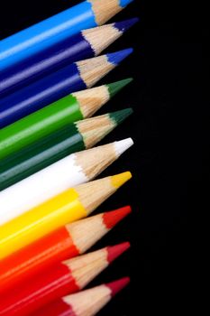 Color pencils isolated on black background