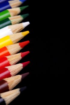 Color pencils isolated on black background