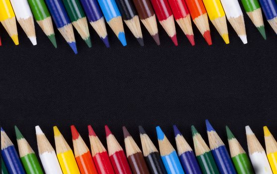 Color pencils isolated on black background