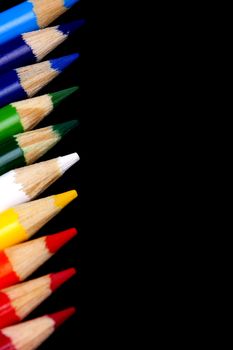 Color pencils isolated on black background