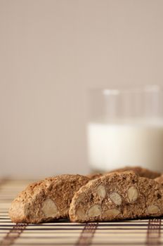 Delicious cantuccini cookies with glass of milk still life