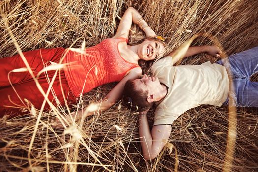 A man and a woman are in a wheat field