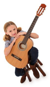 Beautiful ten year old with acoustic guitar over white with clipping path.