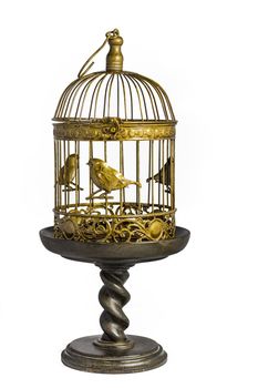 A gold and brown birdcage sitting on top of a decorative pedestal stand.