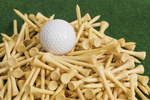 A white golf ball sitting on top of a stack of tees