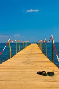 slippers on wooden peer consept of going vacation