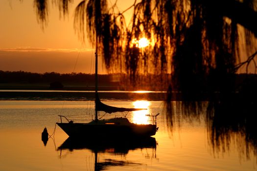 Yacht bathed in early morning golden light.