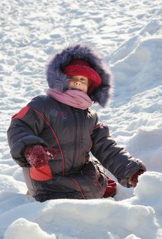 child game of snow on  walk winter