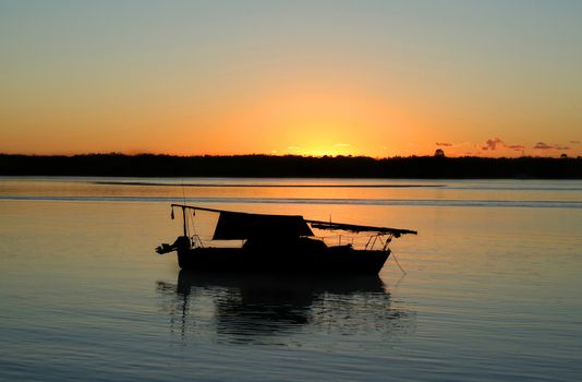 Sailing boat moored in a safe haven before dawn.