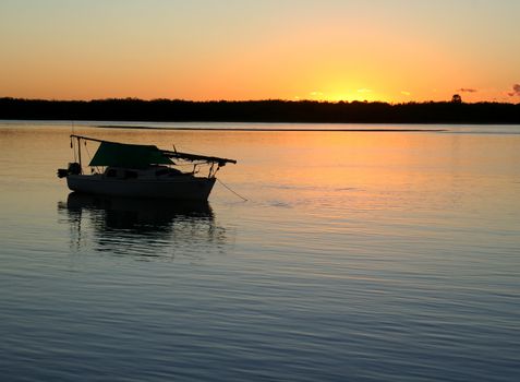 Sailing boat moored in a safe haven before dawn.