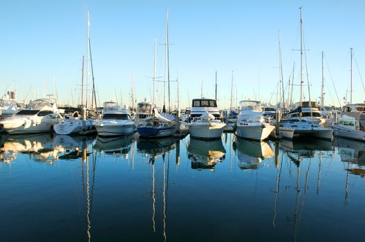 Expensive yachts and boats lined up at the marina at daybreak.