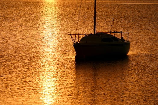 Daybreak with golden light spilling over the water. 