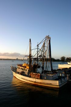 Fishing and prawn trawler at dock in the late afternoon light.