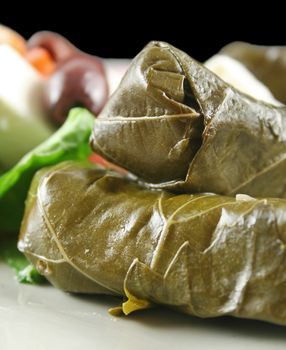 Greek dolmades wrapped with vine leaves and rice with salad.