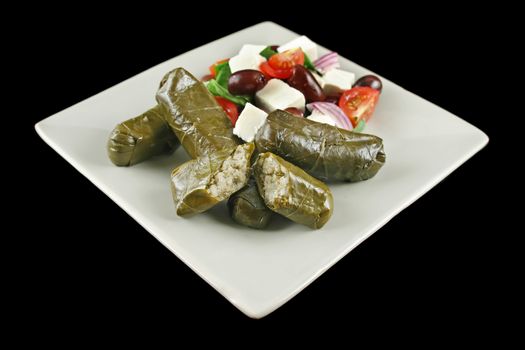 Greek dolmades wrapped with vine leaves and rice with salad.