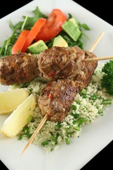 Beef kofta on parsley couscous with a garden salad.