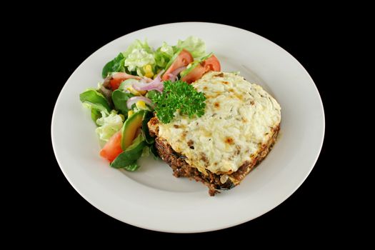 Lamb moussaka with egg plant cheese and salad.