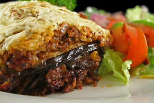 Lamb moussaka with egg plant cheese and salad.