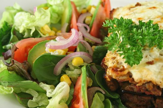 Lamb moussaka with egg plant cheese and salad.