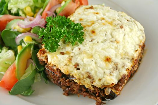 Lamb moussaka with egg plant cheese and salad.