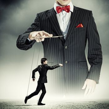 Image of young businessman puppeteer. Leadership concept