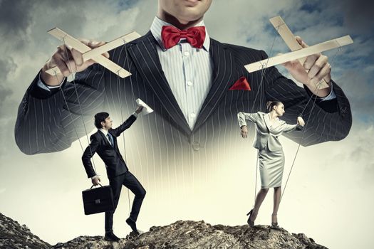 Image of young businessman puppeteer. Leadership concept