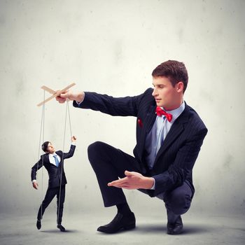 Image of young businessman puppeteer. Leadership concept