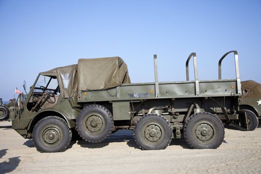 IJMUIDEN, THE NETHERLANDS-MAY 5 2013: Army trucks of organization Kelly's Heroes riding on beach on May 5,2013 in IJmuiden, The Netherlands. Simulate arrival of allies on liberation Second World War