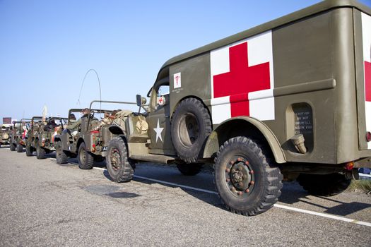 IJMUIDEN, THE NETHERLANDS-MAY 5 2013: Army trucks of organization Kelly's Heroes riding on beach on May 5,2013 in IJmuiden, The Netherlands. Simulate arrival of allies on liberation Second World War