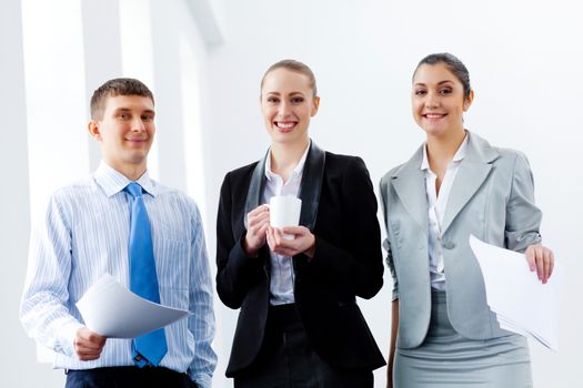 Image of three young businesspeople laughing joyfully