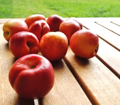 fresh peaches on wooden table

