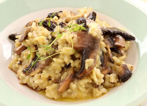 Delicious mushroom risotto served with fresh thyme.